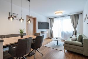 a living room with a table and a couch at Mein Gaisberg in Obergurgl