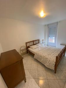 a bedroom with a bed and a table at Villa Garance in Le Tréport