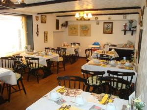 a restaurant with tables and chairs in a room at Spencer Court in Ramsgate