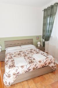 a bedroom with a bed with two laptops on it at Appartamento indipendente in villa in Sanremo