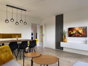 a living room and dining room with a table and chairs at Ferienhaus Bodensee - by Heinke Wohnraum in Oberteuringen +32 photos
