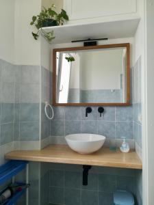 a bathroom with a sink and a mirror at Domo Sul Porto in Stintino