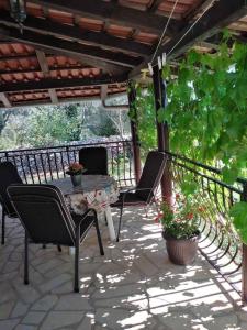 a patio with a table and chairs on a patio at Apartman Krčina in Krnica