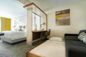 a hotel room with a couch and a bed at SpringHill Suites by Marriott Athens West in Athens