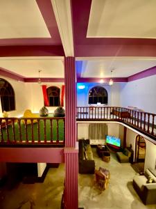 ein Wohnzimmer mit einem Balkon und einem Sofa in der Unterkunft Tashila Hostel in Gangtok