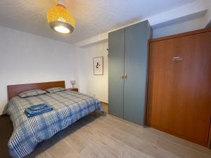 a bedroom with a bed and a wooden cabinet at Appartement Luxembourg centre in Luxembourg