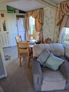 a living room with a couch and a table at Windermere in Morecambe