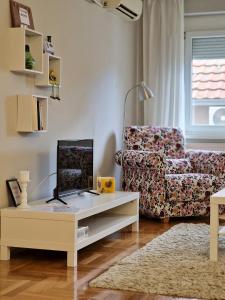 a living room with a couch and a coffee table at Quiet Center in Sremska Mitrovica