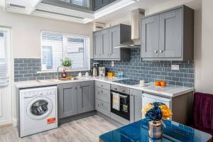 a kitchen with a washer and dryer at ALBERT COURT in Castletown