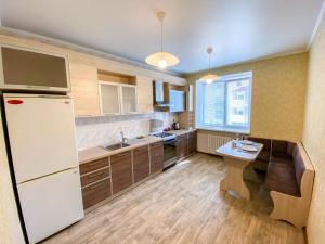 a kitchen with a white refrigerator and a sink at 1-кімн Простора квартира в НОВОМУ будинку в самому серці Полтави in Poltava +8 photos