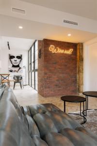 a living room with a couch and a brick wall at Patio de Luces in Jumilla