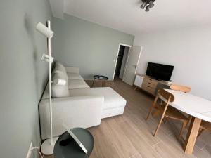 a living room with a white couch and a table at Appartement Luxembourg centre in Luxembourg