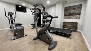 a gym with two tread machines and a treadmill at Aparthotel Luz de Gades - Suites Spa Gym - Adults Only in Cádiz