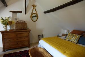 a bedroom with a bed and a dresser and a mirror at Le Montillon in Tour-en-Sologne +34 photos