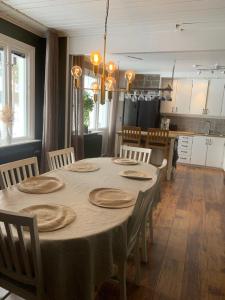 a dining room with a table and a kitchen at Lovely house with a beautiful view in Jokkmokk in Jokkmokk