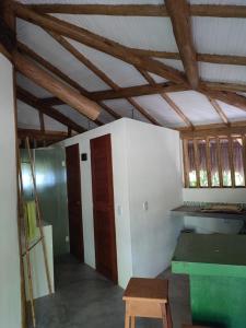 an empty room with a ceiling with wooden beams at Seafront Chalet Cocoa Coast in Ilhéus
