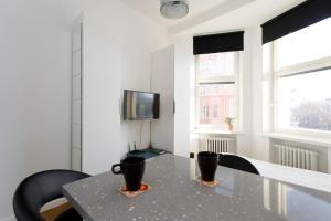 a dining room with a table with two cups on it at Stylish studio in the centre in Helsinki
