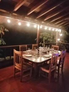 a dining room table with chairs and a tableablish at CasaBravaVentura Jungle Ecofarm in Santa Catalina