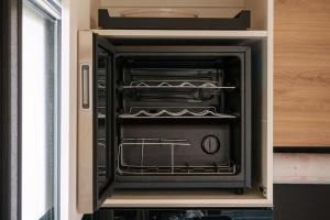 an oven with its door open in a kitchen at Velo & Wohnen -NEU- Elektroräder inklusive-Sauna-Moselblick in Enkirch