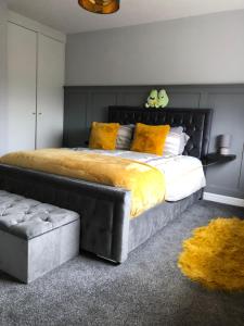 a bedroom with a large bed with yellow pillows at Fraunhill in Swinford