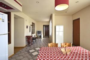 a kitchen and dining room with a table and chairs at Ararat view 3-bedroom apartment with garden in Yerevan