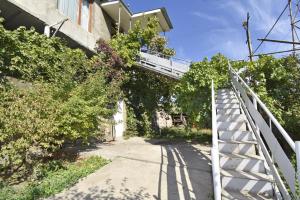 a stairway leading up to a building with trees at Ararat view 3-bedroom apartment with garden in Yerevan