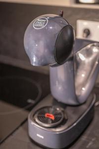 a tea kettle sitting on top of a stove at Appartement - Le Mikado - Hyper-centre - Wi-Fi- Espace de travail - Confort in Saint-Étienne