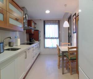 uma cozinha com uma mesa e uma sala de jantar em Grande, luminoso y con garage, 3 dormitorios en el camino de Santiago em Burgos