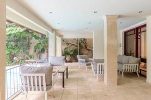 a patio with chairs and a table on a balcony at Heated Pool! 1 Minute Walk To The Beach! PURA VIDA Villa in Herzliya