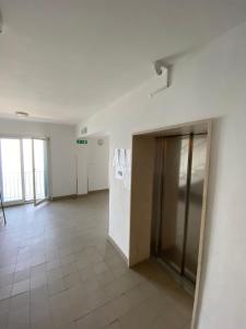 an empty room with a door and a tile floor at Lucy Apartment Piran-Punta in Piran