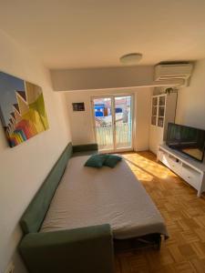 1 dormitorio con 1 cama grande y TV de pantalla plana en Lucy Apartment Piran-Punta, en Piran