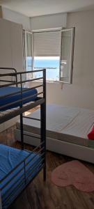 a bedroom with two bunk beds and a window at Residence Adriatico in Lido Adriano