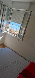 a bedroom with two windows and a bed in it at Residence Adriatico in Lido Adriano