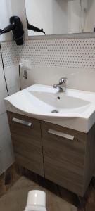a bathroom with a white sink and a toilet at Residence Adriatico in Lido Adriano