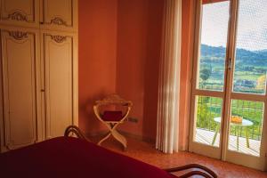 a bedroom with a mirror and a large window at Casa di nonna in Bevagna