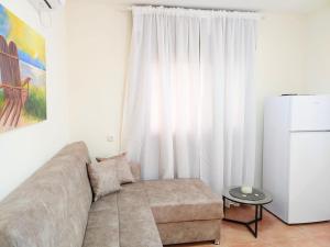a living room with a couch in front of a window at Spot in the Village פינה במושב in Livnim