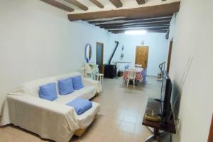 a living room with two white couches and a tv at LA GRAN VÍA in Bocairent