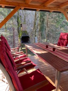 a group of chairs sitting on a deck with a fireplace at Vintage Holiday House in Šoštanj
