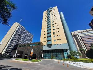 a tall building with two tall buildings at Flat particular no Lets Idea Brasília in Brasilia