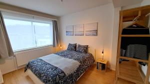 a bedroom with a bed and a large window at Chez la Baronne in Brussels