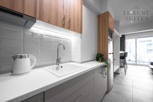 a kitchen with a sink and a counter top at Horizon Apartments, The Luxury Suites in Thessaloniki