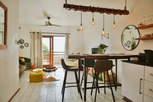 a kitchen with a table and chairs in a room at Umdloti Jungalow in Umdloti