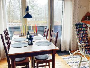 uma sala de jantar com uma mesa de madeira e cadeiras em Holiday home KORSBERGA II em Korsberga