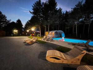 a resort with a swimming pool and a tent at OŚRODEK U POLAKA domki góralskie 