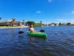 a woman sitting in a kayak on a lake at Wildlife Views & Fishing Villa in Cape Coral