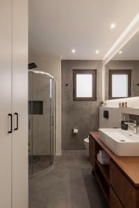 a bathroom with a sink and a shower at Chania City Luxury Dreams Apartment in the Heart of Chania in Chania