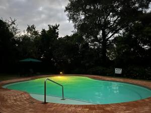 a small swimming pool with a light in the middle at Rifumo Luxury Villa in Kruger Park Lodge in Hazyview