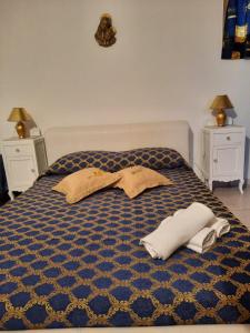 a bed with two pillows and towels on it at Villa mendola in Cianciana