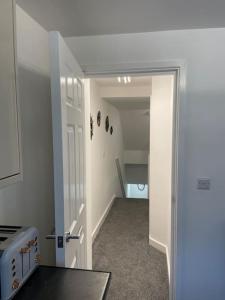 a hallway with an open door to a room at Luxury Town Center Studio Stevenage in Stevenage