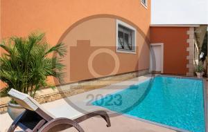 a villa with a swimming pool and a house at Lovely Home In Sisan With Outdoor Swimming Pool in Šišan
